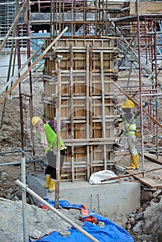 Two of construction worker fabricating column formwork
