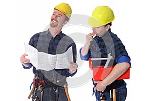Two construction workers with architectural plans