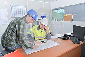 Two construction workers discussing plans