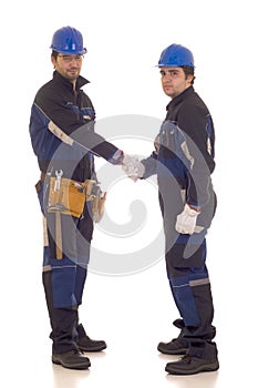 Two construction workers handshake.