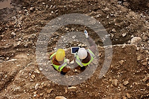 Two Construction Workers Inspecting Site