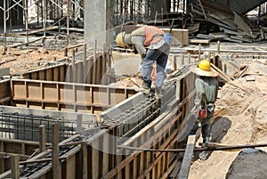 Two Construction Workers Installing Ground Beam Formwork