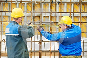 Two construction workers making reinforcement