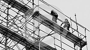 Two Construction Workers on Scaffolding in Black and White