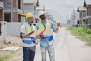 Construction workers evaluating residential project site with focus and planning mindset