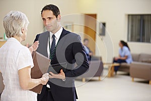 Two Consultants Discussing Patient Notes In Hospital