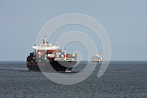 Two container ships pass at sea