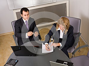 Two contemporary businesspeople at a meeting