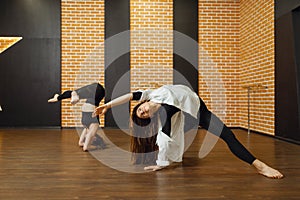 Two contemporary dance performers poses in studio