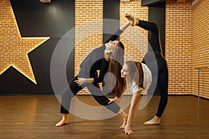 Two contemporary dance performers poses in studio