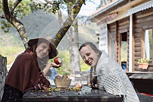 Two Contryside friends eating apple and smile
