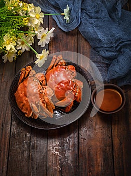 Two cooked crab is on the table.