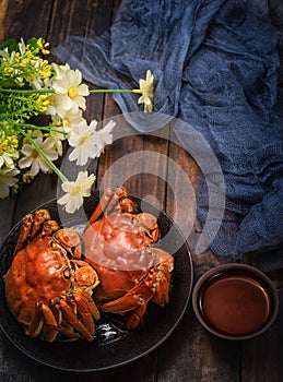 Two cooked crab is on the table.