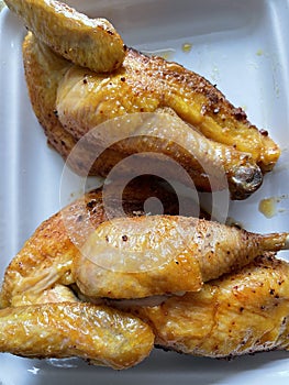 Two cooked half chickens on a plate