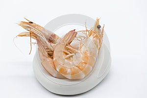 Two cooked prawns in an original plate