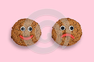 Two cookies with plasticine eyes and lips