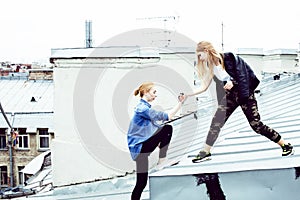 two cool blond real girls friends making selfie on roof top, lif