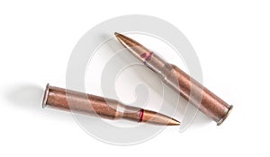 Two copper machine gun bullets isolated on white background