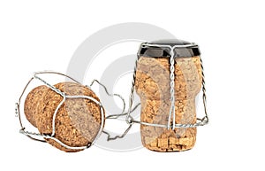 Two corks of champagne with muselet isolated on white background