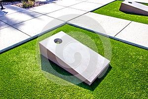 Two Cornhole Boards On Synthetic Turf