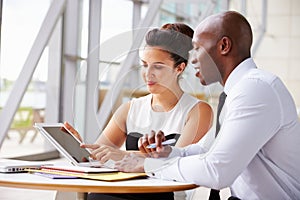 Two corporate business colleagues working together in office