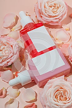 Two cosmetic bottle with pipette on pink background with rose flowers and petals, product packaging, anti aging serum