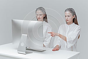 Two cosmic women sitting at the computer