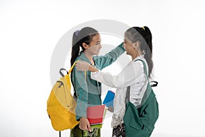 Two couple student meet friend carrying bag and books in traditional clothes photo