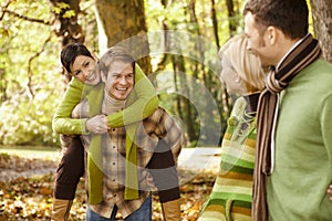 Two couples having fun in autumn park