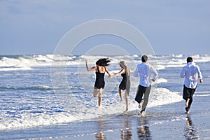 Two Couples, Having Fun On A Beach