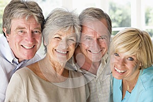 Two couples indoors smiling