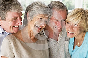 Two couples indoors smiling