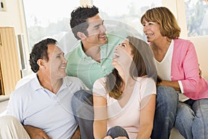 Two couples sitting in living room smiling