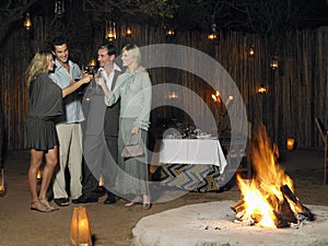 Two Couples Toasting At Outdoor Nightclub