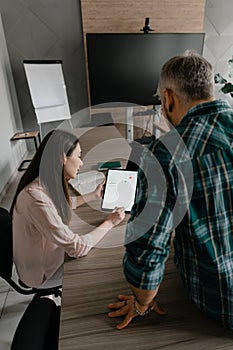Professionals collaborating on financial data in a modern office setting