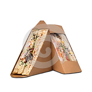 Two crab sticks mayonnaise sandwiches in a paper box