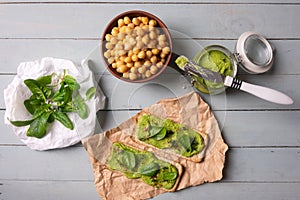 Two crackers with green spinach humus photo