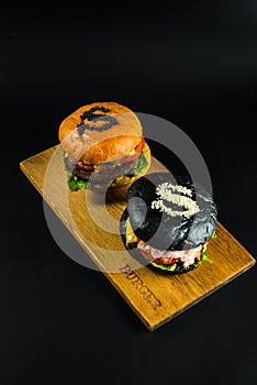 two crafting a burger on the board photo