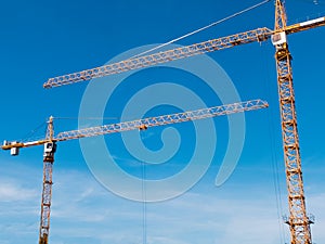 Two cranes opposite each other visually create an arch.