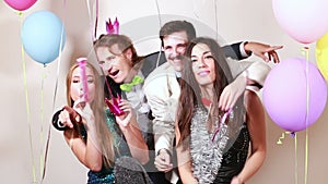 Two crazy couples having a great time in photo booth
