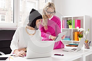 Two creative women working together in office