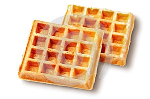 Two crispy fried french waffles isolated on white