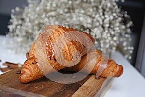 Two croissant in the wooden desk on a morning