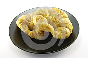 Two Croissants on a Black Plate