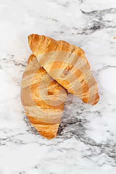 Two Croissants over a Marble Background