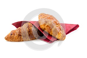 Two croissants on red napkin