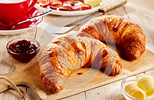 Two croissants, served with jam and butter