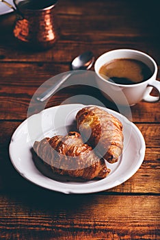 Two Croissants on White Plate and Cup of Black Coffee