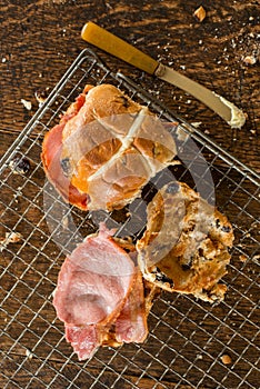 Two Cross Buns on Wire Cooling Rack Beside Butter Knife