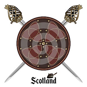 Two crossed Scottish Highland backsword and Scottish battle shield decorated with studs in the Celtic style